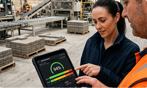 Two quality team members reviewing an inspection result on a tablet on the warehouse floor